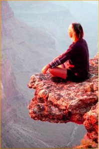 woman-meditating-on-cliff-extension-jutting-out